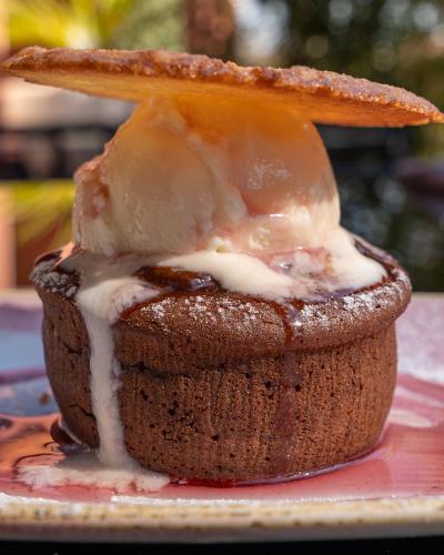 a cupcake on a plate with ice cream on top at Kyriad Lyon Sud Sainte Foy in Sainte-Foy-lès-Lyon