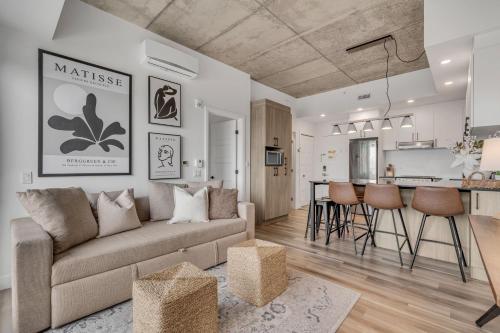 a living room with a couch and a kitchen at Initial-Matisse- Quebec-parking and pool in Quebec City