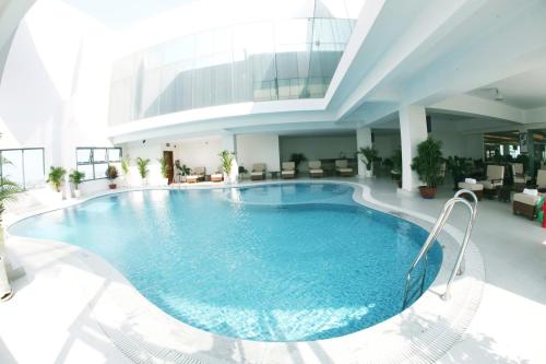 a large swimming pool in the middle of a building at AURORA Hotel Plaza in Bien Hoa