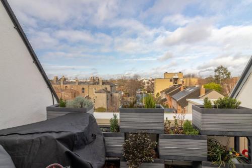 a balcony with potted plants and a view of a city at GuestReady - Marvellous home in Seabury in Dublin