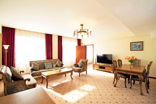 a living room with a couch and a table at Kempinski Hotel Khan Palace in Ulaanbaatar