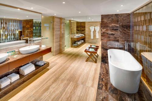 a bathroom with two sinks and a large tub at Kempinski Hotel Corvinus Budapest in Budapest