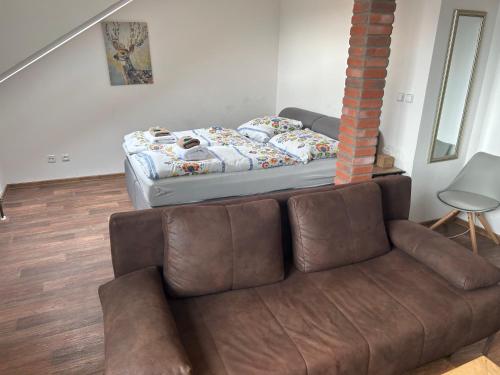 a couch in a living room with a bed at JEZ&SPI Plánice in Plánice