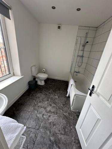 a bathroom with a toilet and a shower and a sink at Riverside Relax 1 bedroom near Airport and City Centre PL in Liverpool