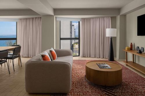 a living room with a couch and a table at ROK Hotel Kingston Tapestry Collection By Hilton in Kingston