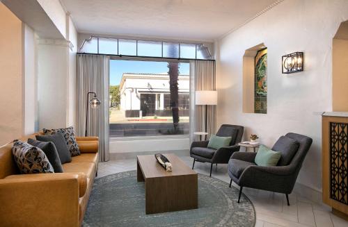 a living room with a couch and two chairs at Hotel Virginia Santa Barbara, Tapestry Collection by Hilton in Santa Barbara
