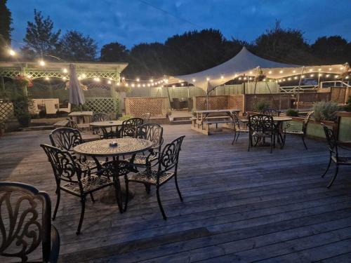 a patio with tables and chairs and a tent at The Squirrel in Godalming
