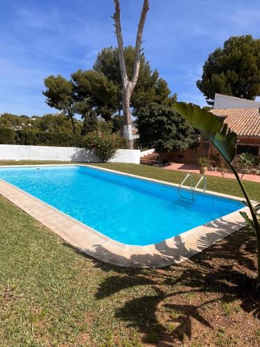a swimming pool in the yard of a house at Villa Portitxol en Moraira in Moraira