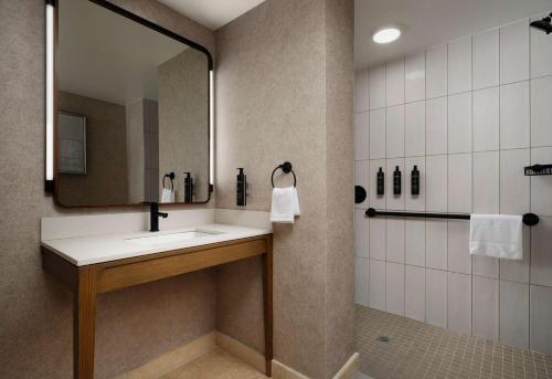 a bathroom with a sink and a mirror at Hotel Flor Tampa Downtown, Tapestry Collection By Hilton in Tampa