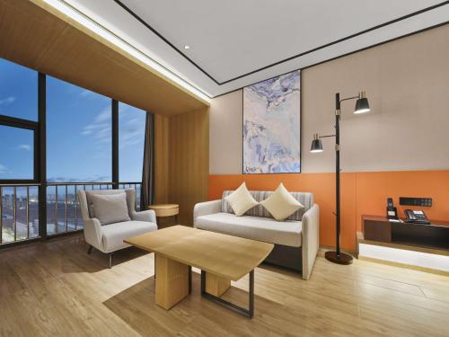 a living room with a couch and a table at Hilton Garden Inn Jinzhong Yuci in Jinzhong