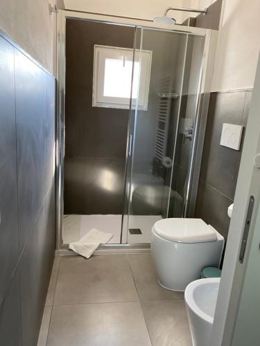 a bathroom with a shower and a toilet and a sink at Residenza Segrate Centro Novegro in Segrate