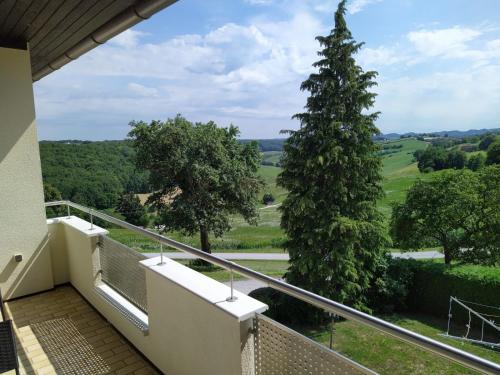 a balcony with a view of a tree at Raus aufs Land in Ederberg