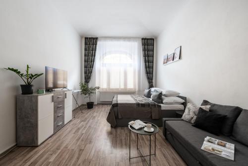 a living room with a couch and a table at Prague - Karlin Apartments in Prague