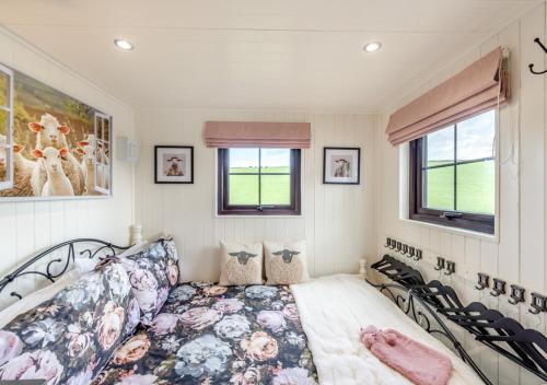 a bedroom with a bed and a window at Little Bo Peep in Fremington