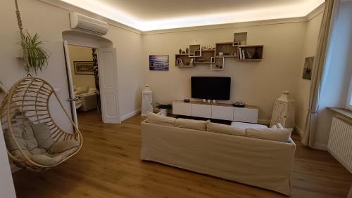 a living room with a couch and a television at Mare e Monti in Genova