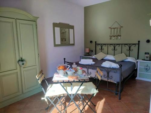 a bedroom with a bed and a table and chairs at Villa Albina in La Loggia