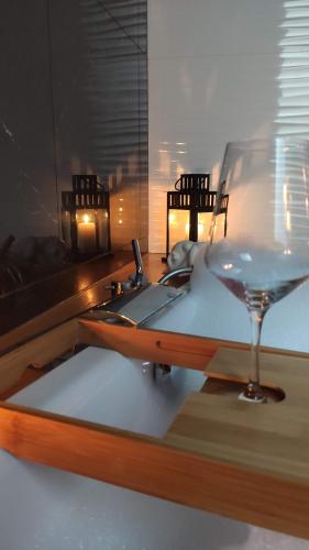 a glass of wine sitting on a table with a sink at Mare e Monti in Genova