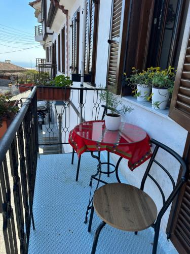 a patio with a table and chairs on a balcony at Old Town Traditional Residence in Kavala