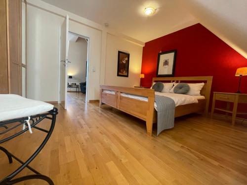 a bedroom with a bed and a red wall at Hotel Schloss Zell in Zell an der Mosel