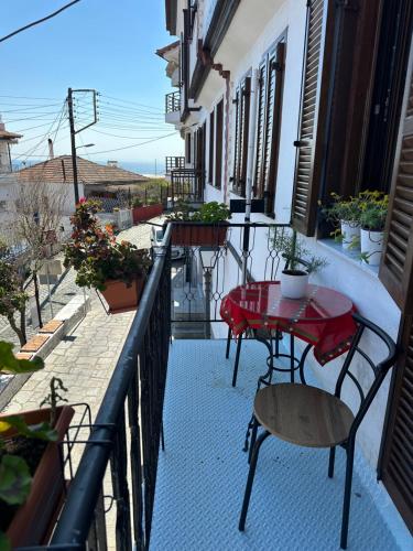 a balcony with tables and chairs on a building at Old Town Traditional Residence in Kavala