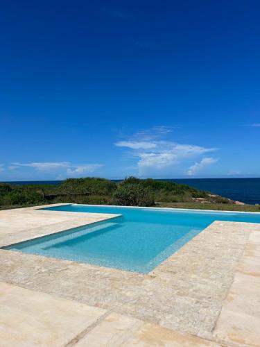 a swimming pool with the ocean in the background at Sea view house in Kilifi