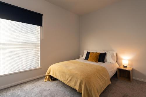 a bedroom with a bed and a large window at Stylish 3Bed House in Hull - sleeps 5 in Hull