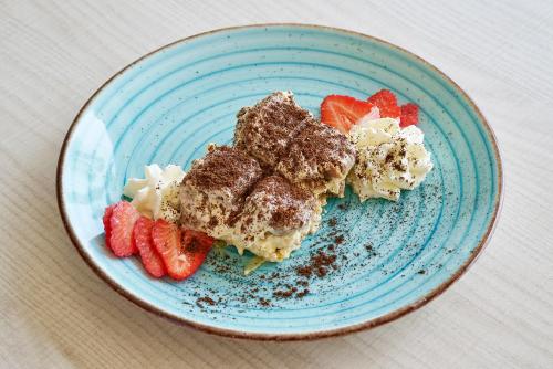 a blue plate of food with strawberries on it at URH Excelsior in Lloret de Mar