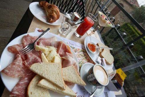 a plate of food with meat and bread on a table at La Giuggiola in Arqua Petrarca