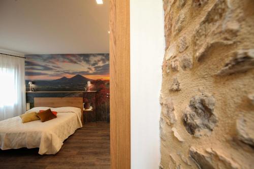 a bedroom with a bed and a painting on the wall at La Giuggiola in Arqua Petrarca