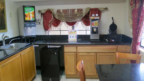 a kitchen with a counter and a sink and a counter top at Calimesa Inn in Calimesa
