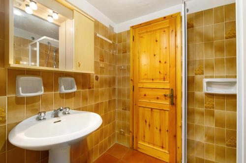 a bathroom with a sink and a mirror at Casa Betulla Champorcher in Champorcher