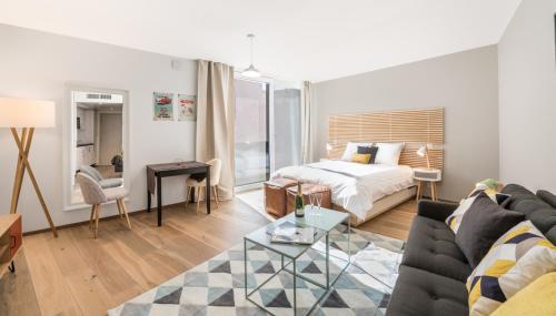 uma sala de estar com uma cama e um sofá em N20 Residence by Homenhancement em Genebra