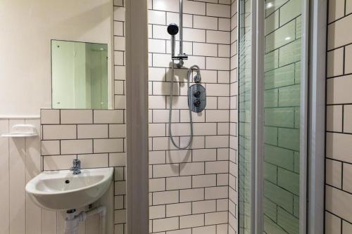 a bathroom with a shower and a sink at Riverside Flat in Inverness