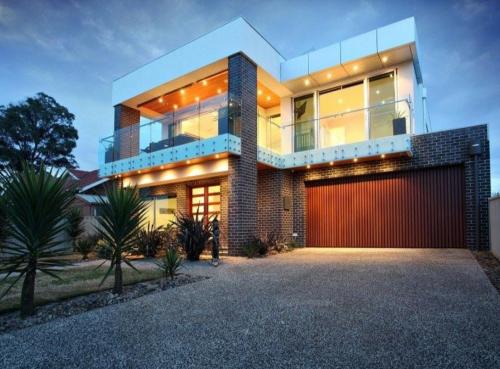 a house with a red garage in front of it at Geelong Beach Q House in North Shore