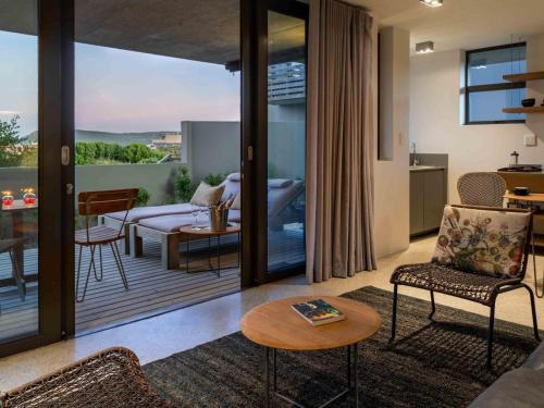 a living room with a couch and a table at Christiana Lodge in Plettenberg Bay