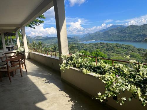 a balcony with a view of a lake and mountains at Par 5 Golf Villa in Digana