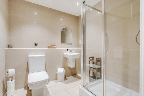 a bathroom with a shower and a toilet and a sink at GuestReady - One modern and calm city refuge in Liverpool