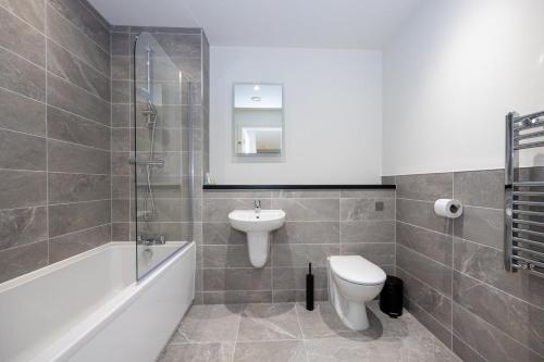 a bathroom with a sink and a toilet and a shower at GuestReady - Elegant Tranquility in Vauxhall in Liverpool