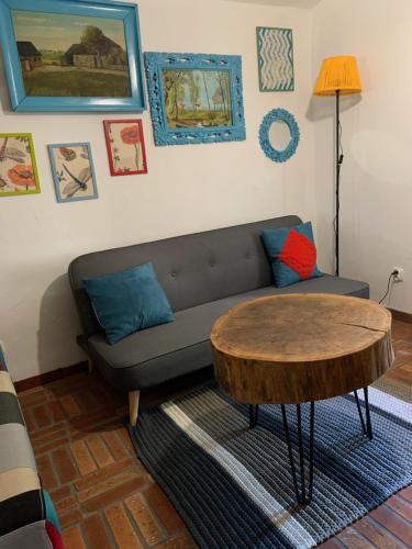 a living room with a couch and a table at Siedlisko Karczówka in Wieleń