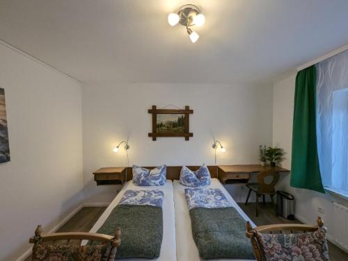 a living room with two beds and a table at Haus Am Waldesrand in Herzberg am Harz