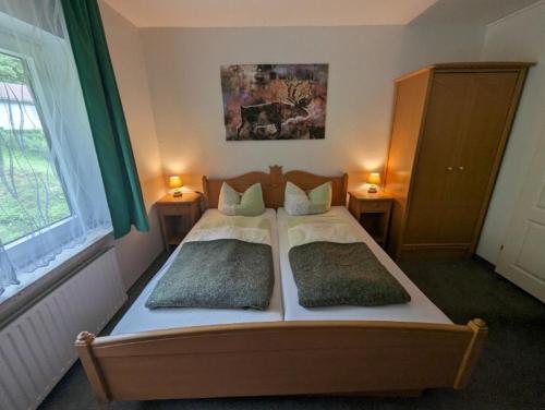 a bedroom with a bed with two pillows on it at Haus Am Waldesrand in Herzberg am Harz
