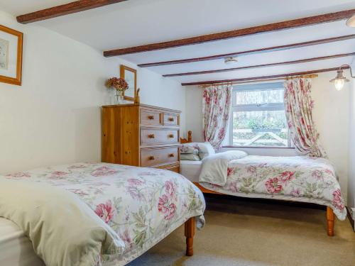 a bedroom with two beds and a window at 3 Bed in Newquay 82369 in Mitchell