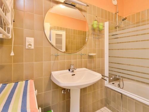a bathroom with a sink and a mirror and a tub at Wellington I C5 051 in Wenduine