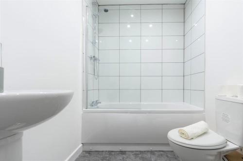 baño blanco con bañera, aseo y lavamanos en Riverside Rendezvous 1 bedroom Near Airport and City Centre SF en Liverpool
