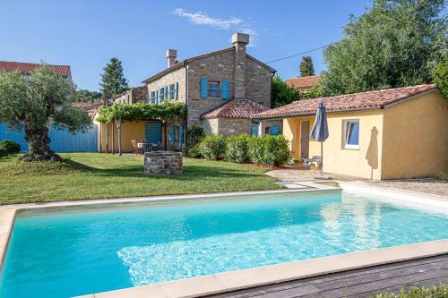 a swimming pool in the yard of a house at Pool Villa Lavanda in Šmarje