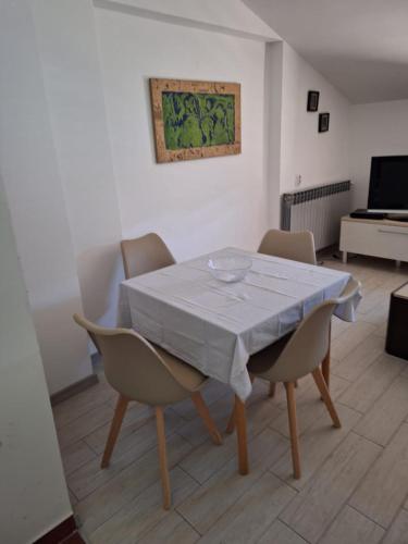 a dining room table with a white table cloth on it at Apartments Iva in Kotor