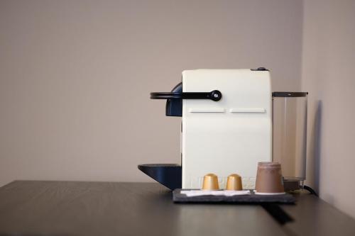 a small white refrigerator with a tray of shoes at Rooms Don Alfonso in Parma