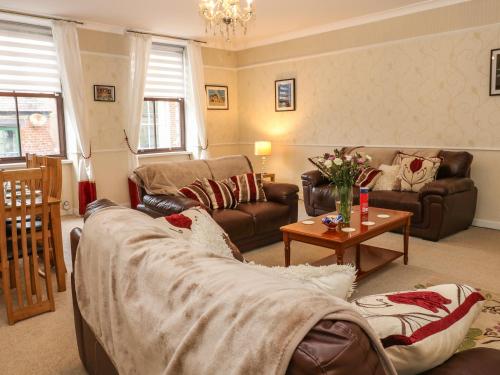 a living room with a couch and a table at The Old Assembly Rooms in Bishop Auckland