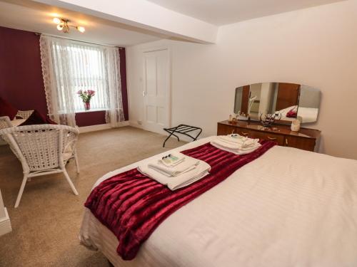 a bedroom with a bed with two towels on it at The Old Assembly Rooms in Bishop Auckland