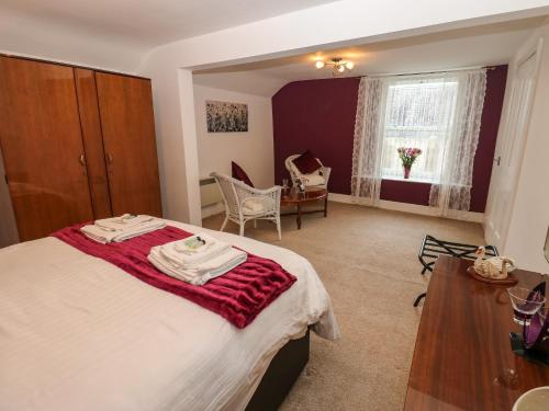 a bedroom with a bed with a red blanket on it at The Old Assembly Rooms in Bishop Auckland